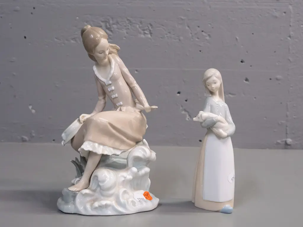 2 Lladro figurines - girl seated on a seaside rock H-235 W-110 and a girl with piglet Image 1++