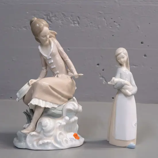 2 Lladro figurines - girl seated on a seaside rock H-235 W-110 and a girl with piglet