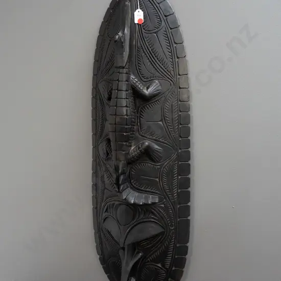 large dark stained carved wood wall shield with crocodile above stylized bird head H-900 W-280