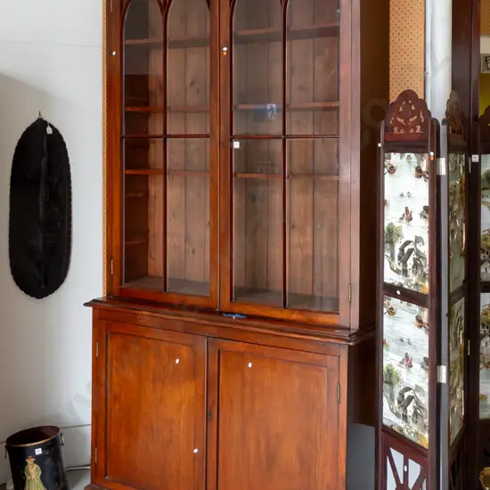 Regency walnut & elm book case astragal arch topped glazed doors above 2 panelled cupboard doors, 3 shelves,  lock &