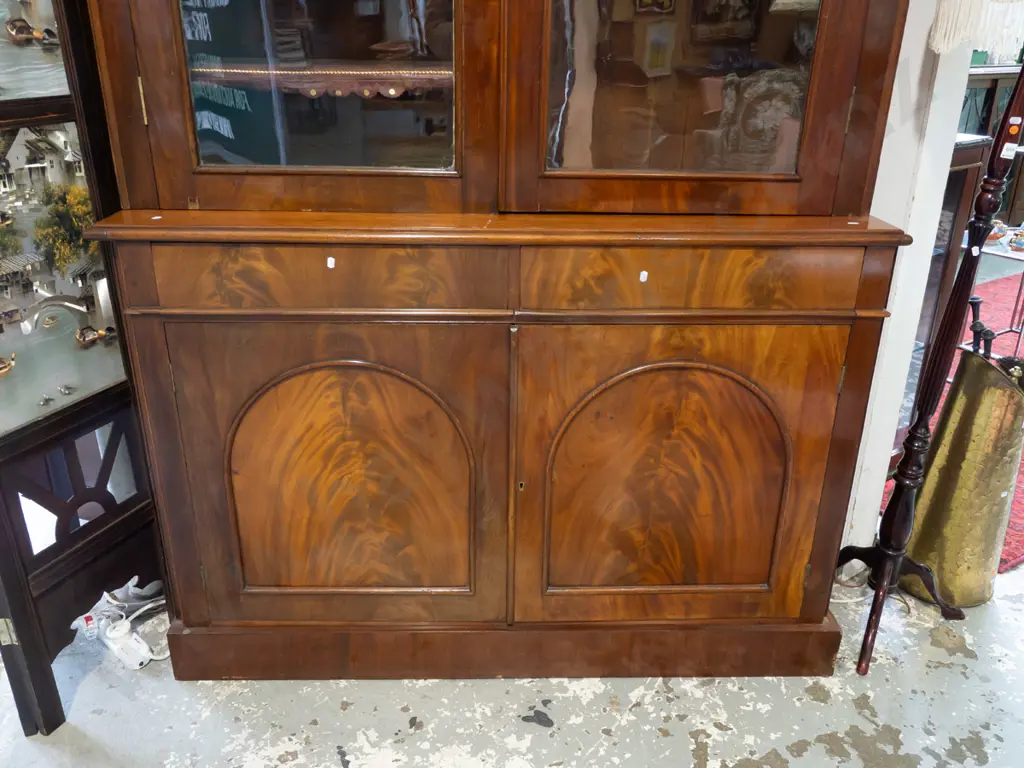 Victorian flame mahogany bookcase chiffonier, dentil moulding to cornice, 2 arched glazed cupboard doors, 8 adjustable Image 1++