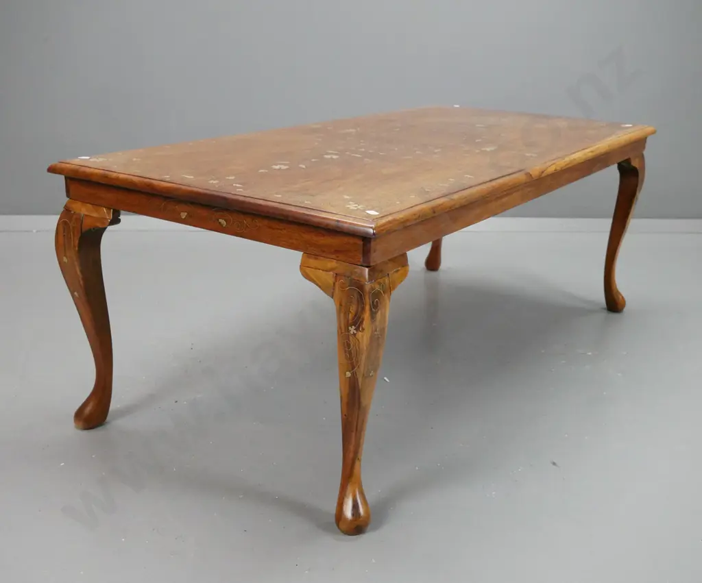 asian teak coffee table with brass scrolling inlays. Repairs to legs, dark filler repair to one leg, missing some inlay. Image 1++