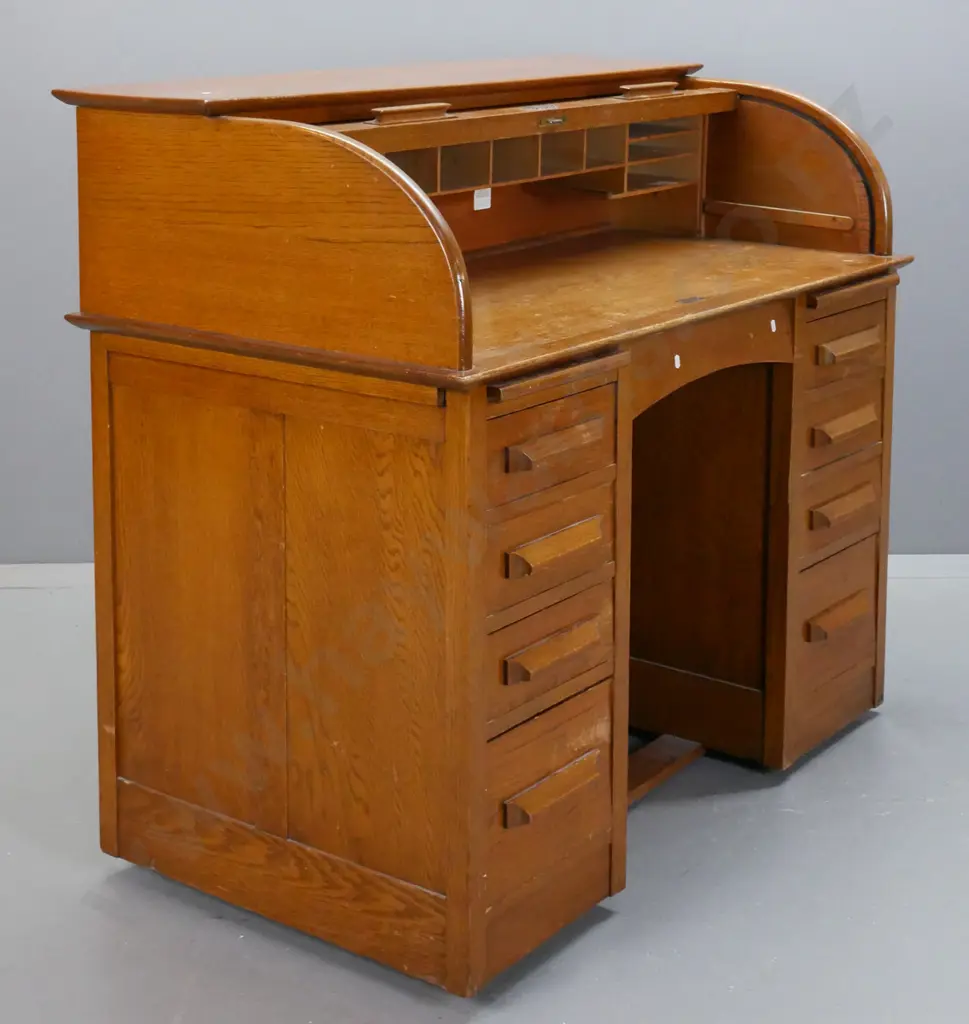 mid-century oak roll-top desk, tambour lid exposing pigeon holes above 2 pedestals w/ 8 drawers & 2 slides. Tambour top Image 1++