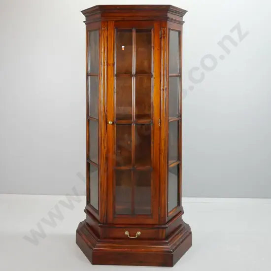 Indonesian mahogany traditional style display case with canted sides, single astragal glazed door, drawer in bottom with