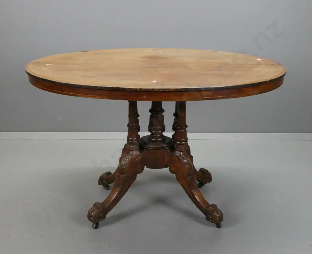 Victorian walnut oval tilt-top loo table on 4-point cathedral base in elm. Some lifting to veneer and fading to surface. Image 1++