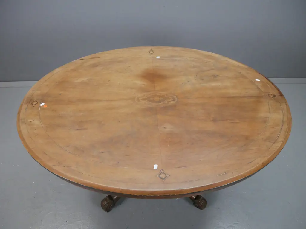 Victorian walnut oval tilt-top loo table on 4-point cathedral base in elm. Some lifting to veneer and fading to surface. Image 1++
