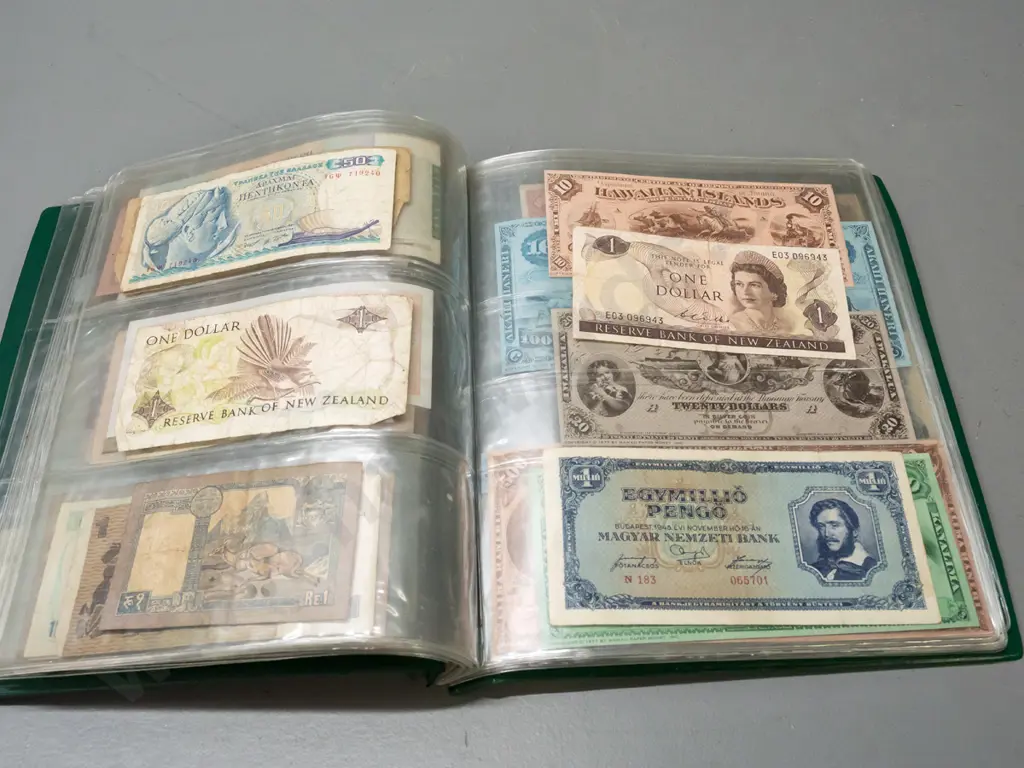 album full of assorted banknotes - a few NZ dollars, otherwise international Image 1++