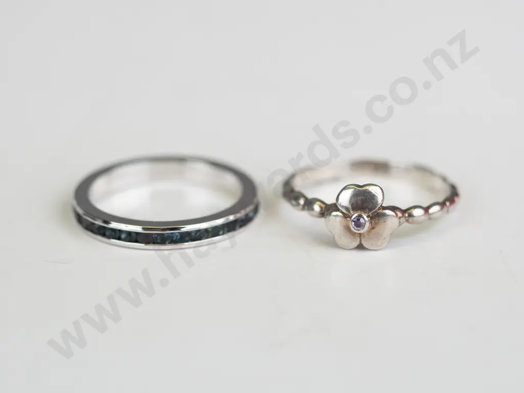 2x sterling  silver rings both stamped 925 - i with dark stones all around & i with a flower Image 1++
