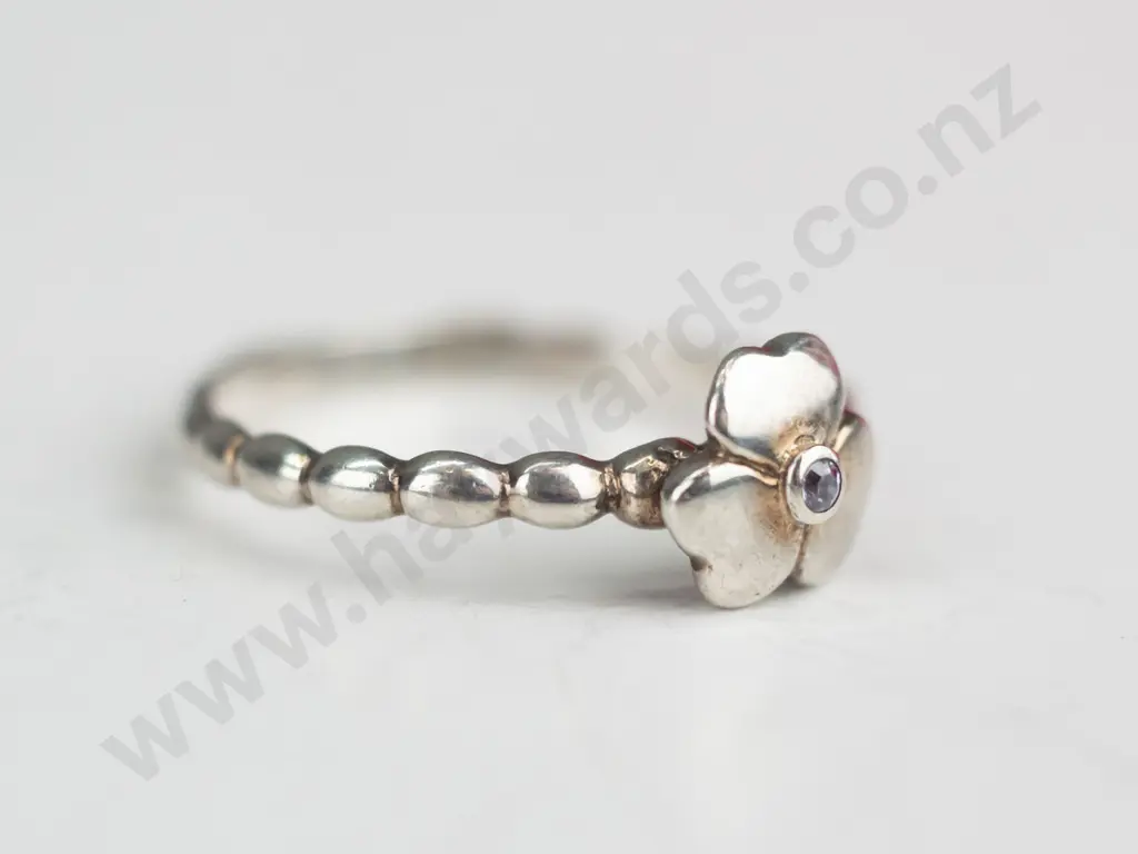 2x sterling  silver rings both stamped 925 - i with dark stones all around & i with a flower Image 1++