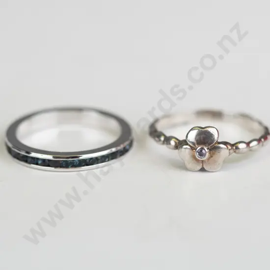 2x sterling  silver rings both stamped 925 - i with dark stones all around & i with a flower
