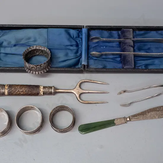 assorted silver napkin rings, sugar tongs, fork with antler handle and butter knife with greenstone handle - most marked