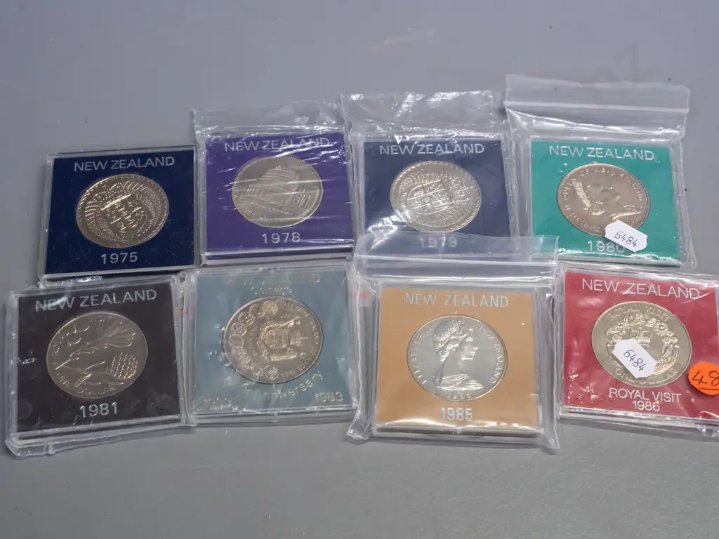 8 New Zealand commemorative dollar coins in plastic cases - 1975, 78,79, 80 81, 83, 85, 86 Image 1++