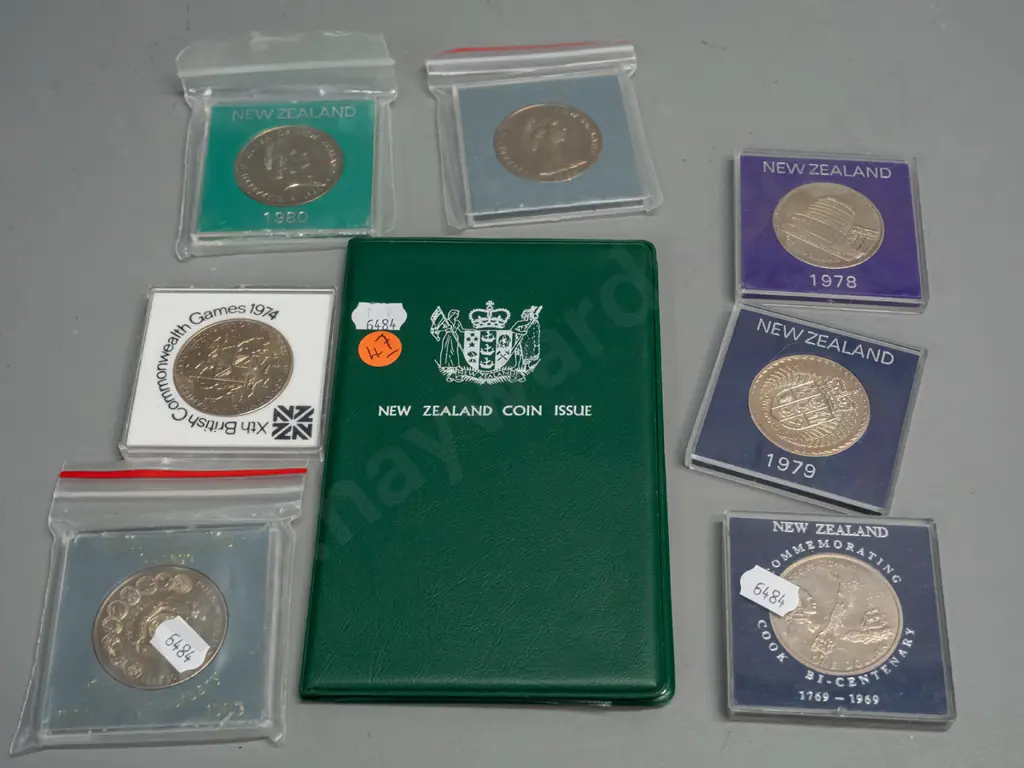 7 New Zealand commemorative dollar coins in plastic cases - 1969, 1974, 78, 79, 1980, two 1983 and a vinyl cased 180 set Image 1++