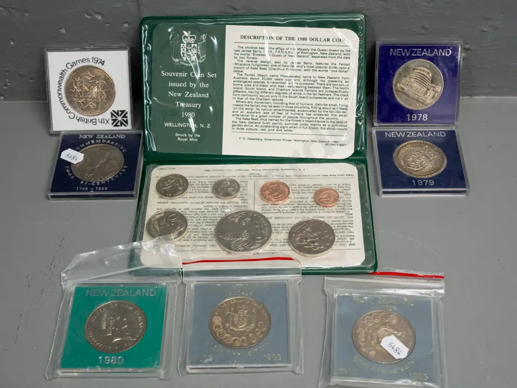 7 New Zealand commemorative dollar coins in plastic cases - 1969, 1974, 78, 79, 1980, two 1983 and a vinyl cased 180 set Image 1++