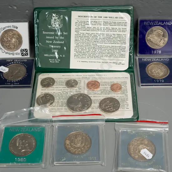 7 New Zealand commemorative dollar coins in plastic cases - 1969, 1974, 78, 79, 1980, two 1983 and a vinyl cased 180 set