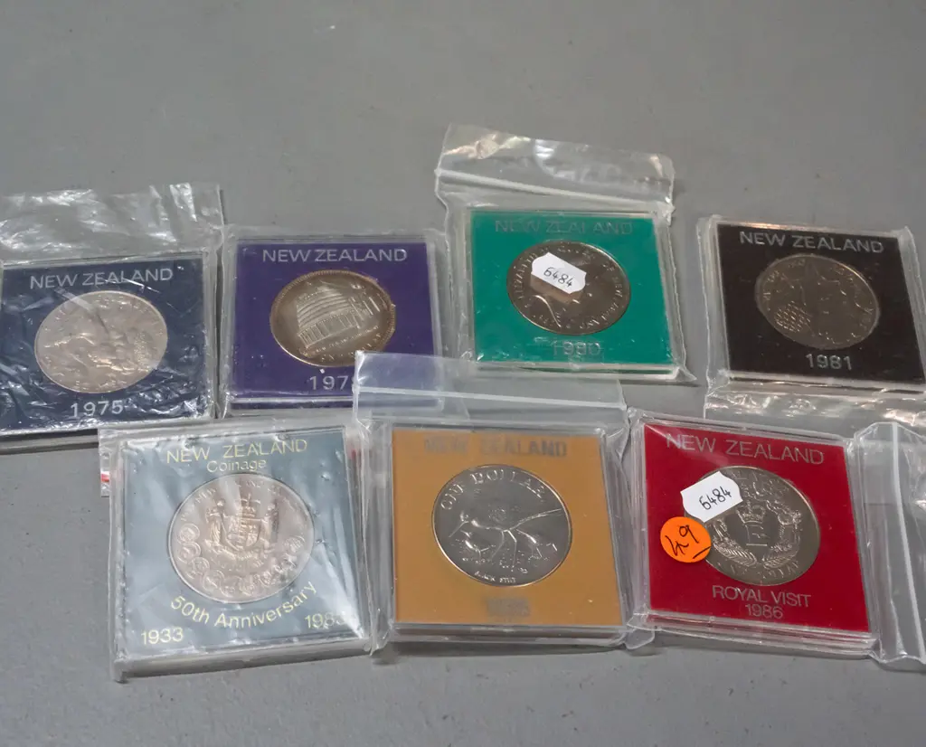7 New Zealand commemorative dollar coins in plastic cases - 1975, 78, 80 81, 83, 85, 86 Image 1++