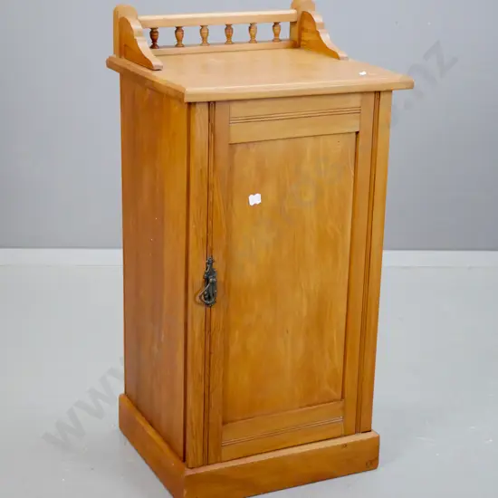 Edwardian rimu bedside cabinet with panelled door, shaped gallery with spindles - borer in bottom plate, filled borer