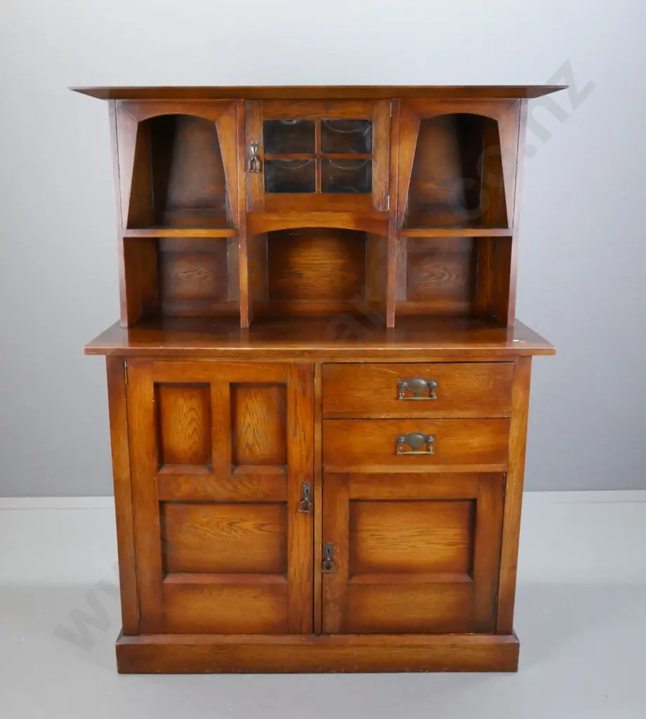 arts & Crafts oak vintage sideboard, small central cupboard door w/ slumped glass panels flanked by 2 arch top shelves Image 1++
