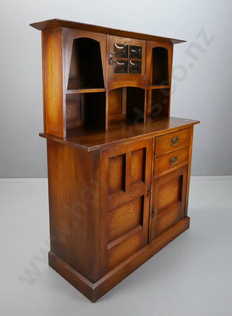 arts & Crafts oak vintage sideboard, small central cupboard door w/ slumped glass panels flanked by 2 arch top shelves Image 1++