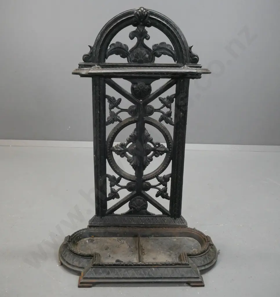 cast metal, Victorian style umbrella/stick stand with arched pierced foliate back on shaped base with lift out drip tray Image 1++