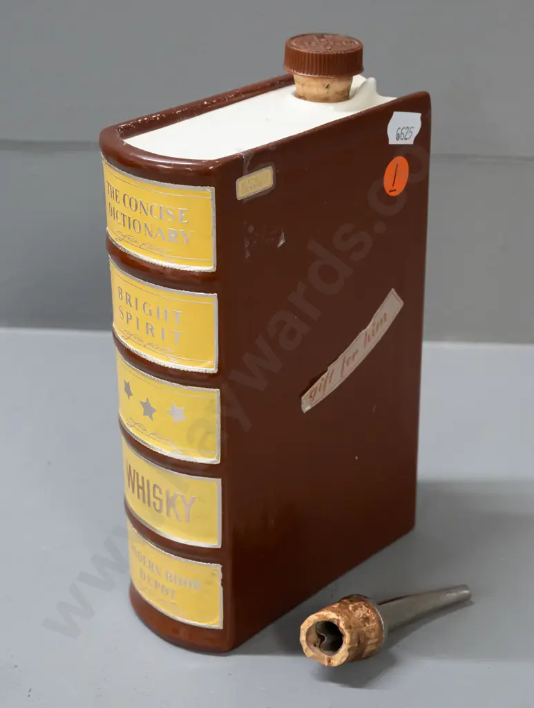 ceramic whisky flask in the shape of a book, with cork stopper and cork-fitted pourer. Some wear to label, tape Image 1++