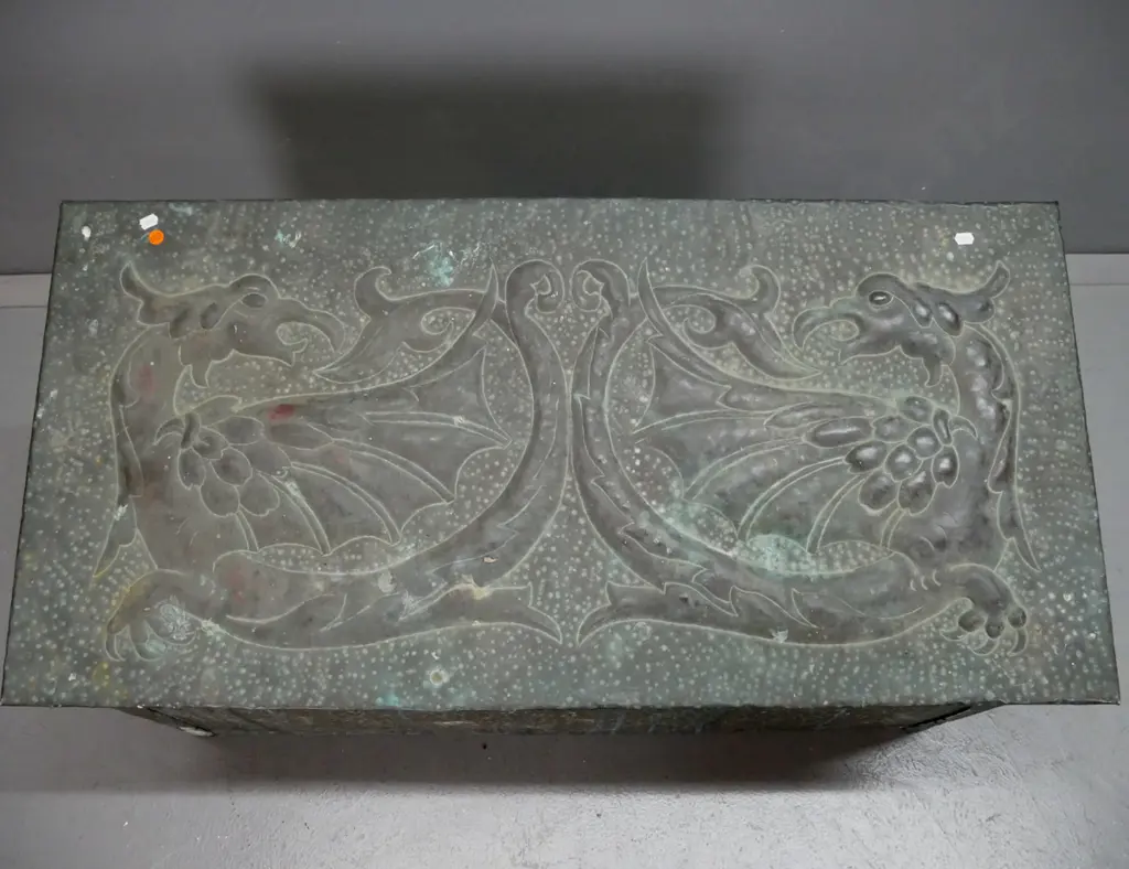 vintage hand-beaten brass woodbox, wood-lined, w/ intertwined dragons to slanted top. Deterioration to wood inside, rust Image 1++