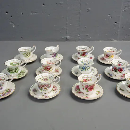 set of 12 Royal Albert months of the year miniature cups & saucers, unique patterns, all months present but July cup has