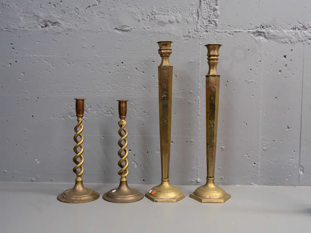 2 pairs of brass candlesticks - engraved larger pair not quite matching, and open-twist pair has some corrosion to base Image 1++