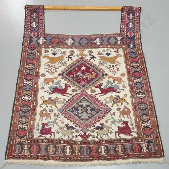 Persian style hand tufted flat weave wool floor rug with rectangular cutout, roughly nailed to pine hanging bar - animal