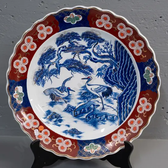 Imari charger with cranes and floral motifs, gilded rim, with folding wood plate stand D-420