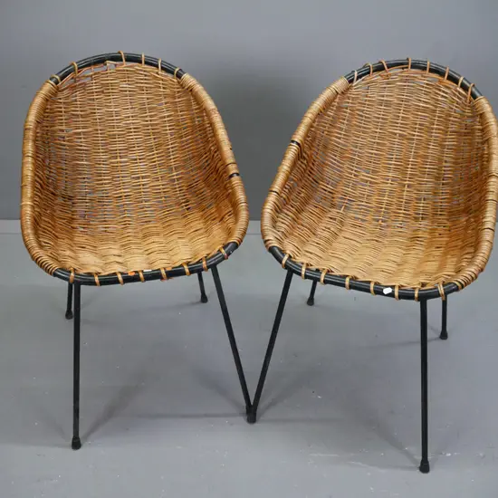 pair of mid-century French woven cane shell chairs with black painted metal frames. Some wear to paint and cracks /