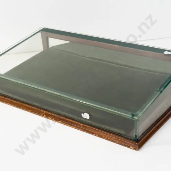 glazed slope fronted counter jewellery display case with hinged mirrored back, felt-lined. Some chipping to edge of