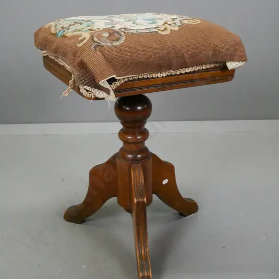 Edwardian revolving piano stool in beech & mahogany, loose-fitting tapestry seat w/ velvet below. On 3 shaped reeded