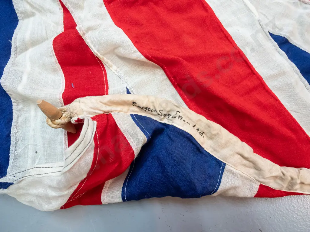 very large New Zealand flag with rope and toggle - has "Sargood Son & Ewen" written on binding. Staining, wear and holes Image 1++