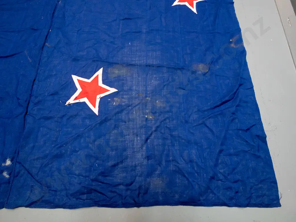 very large New Zealand flag with rope and toggle - has "Sargood Son & Ewen" written on binding. Staining, wear and holes Image 1++