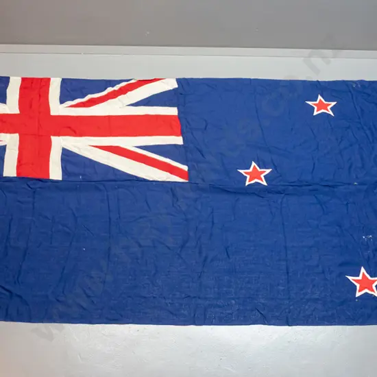very large New Zealand flag with rope and toggle - has "Sargood Son & Ewen" written on binding. Staining, wear and holes