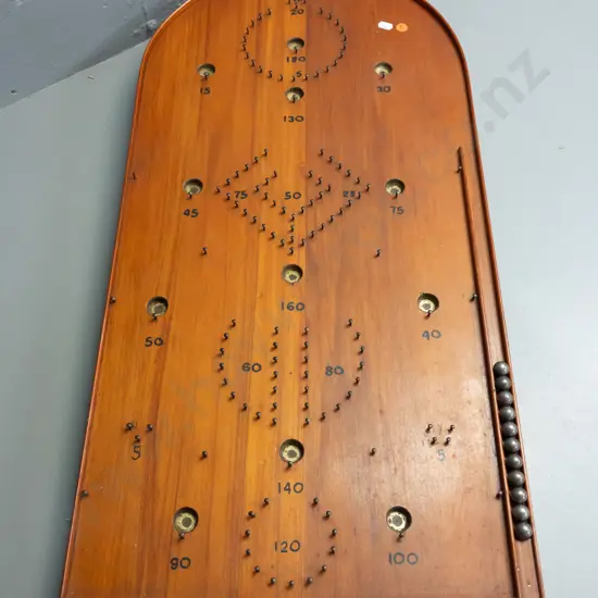 vintage NZ home made rimu bagatelle game board with 11 steel ball bearings in storage cutout inside leg