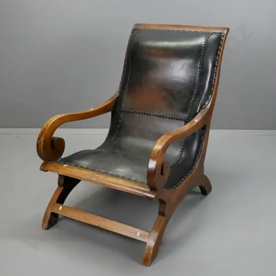 Asian hardwood Plantation Campeche chair with scrolling arms & black leather slung seat w/ leather cord stitching & dome