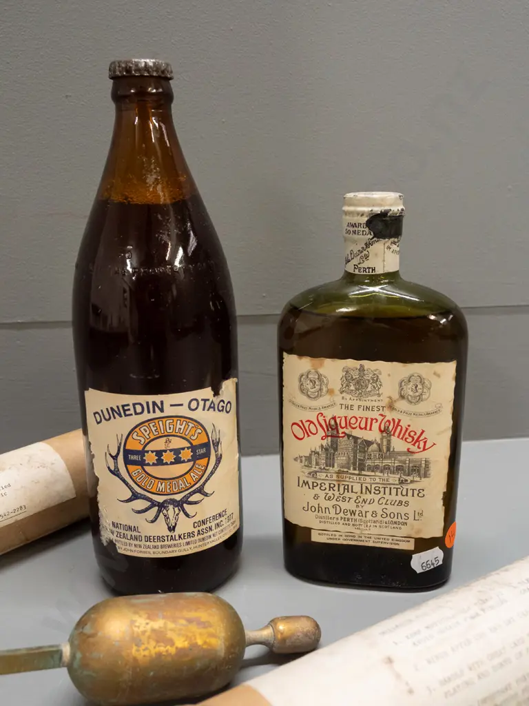 2 brass hydrometers, 1977 Deerstalkers Association Speights beer bottle and John Dewar & Sons whisky, both sealed Image 1++