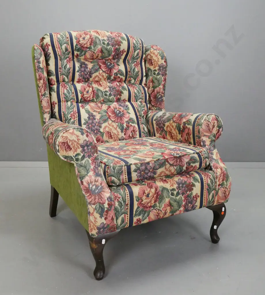upholstered wing back rolled arm chair with deep button back & lift out upholstered seat on short cabriole legs. Floral Image 1++