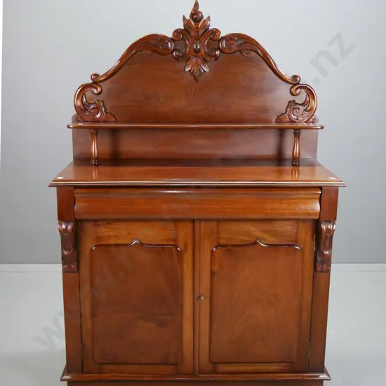 mahogany reproduction carved backed chiffonier, shelf with turned support, above long shaped drawers,
