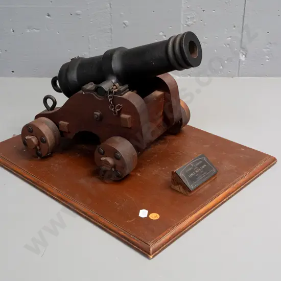 Replica 1/3 scale, cast metal model of signal cannon from HMS Nelson, on wooden base, with plaque