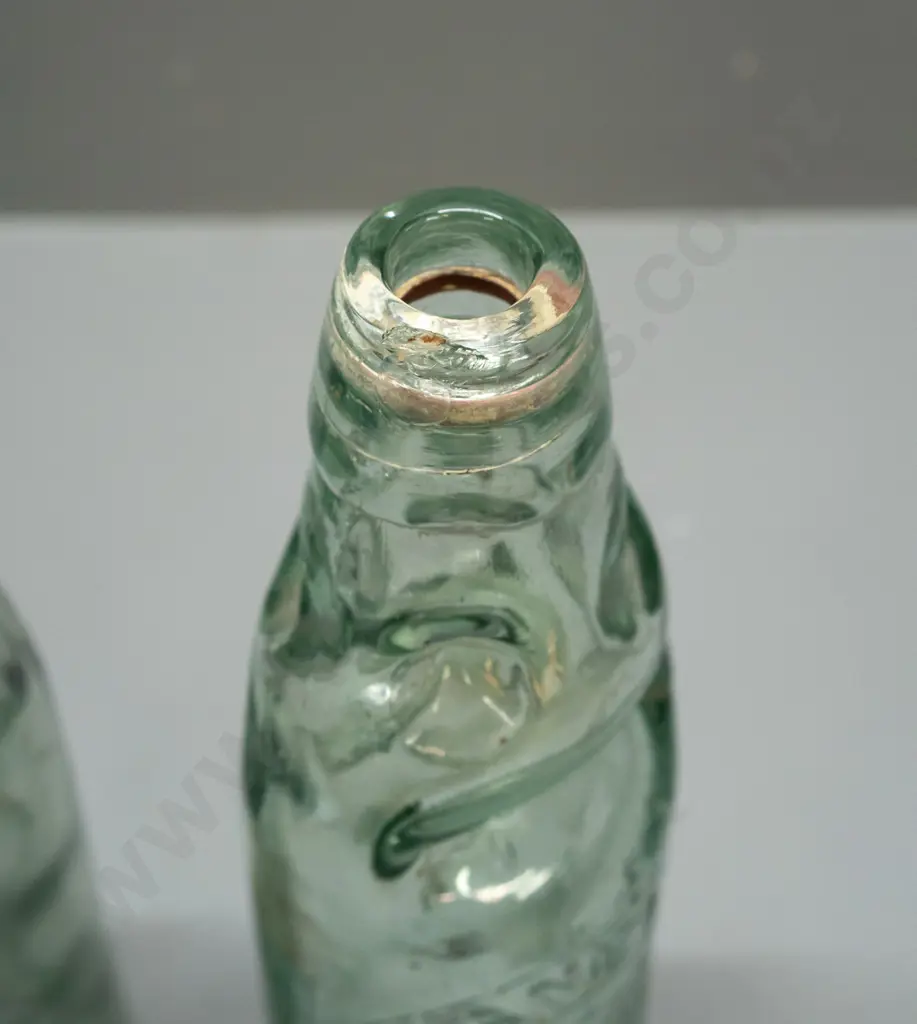 2 codd marble bottles - Lane & Co Dunedin with clear marble, a few chips, and smaller one with black or dark green Image 1++