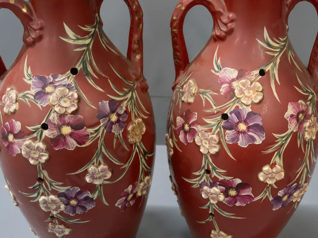 pair of handled vases with applied flowers and Satsuma style decoration, with lines of holes in sides, some staining Image 1++