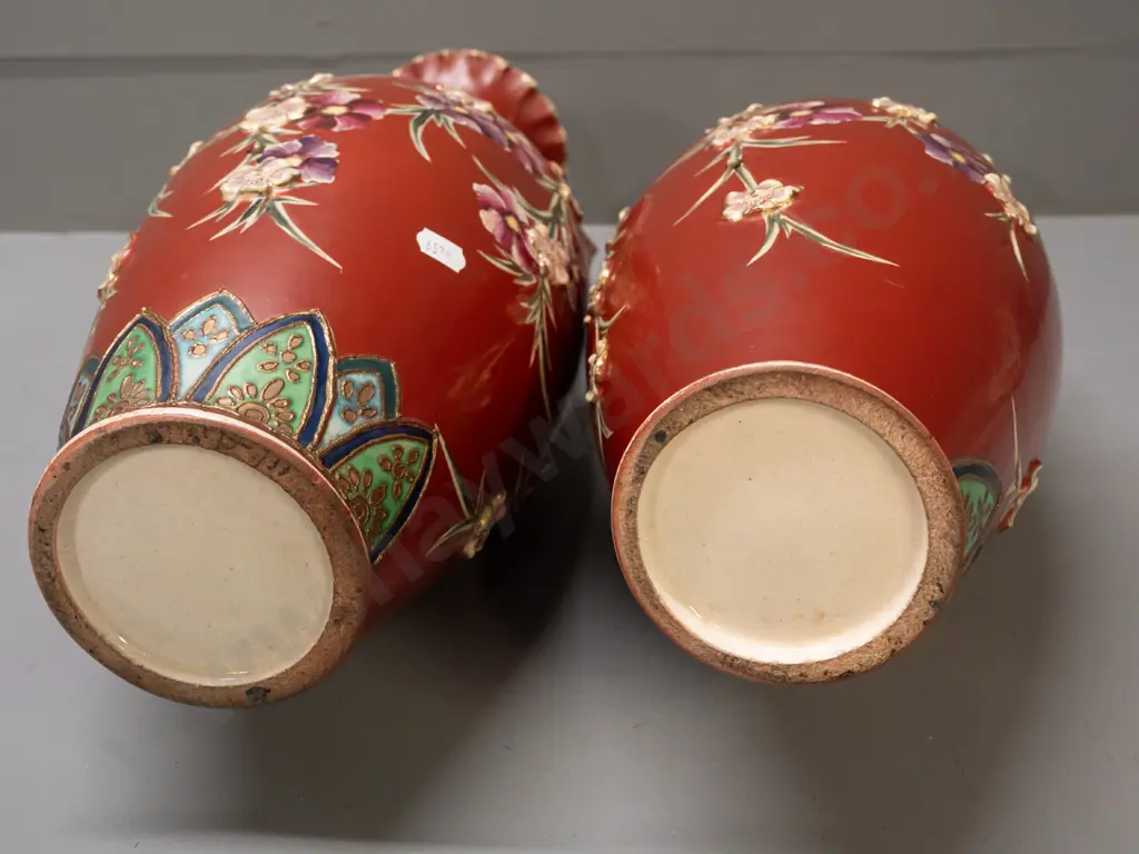 pair of handled vases with applied flowers and Satsuma style decoration, with lines of holes in sides, some staining Image 1++