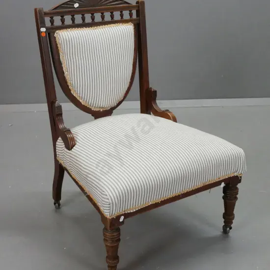 Edwardian walnut bedroom chair w/ oval fan decorated crest above turned gallery, shield-shaped ticking-upholstered