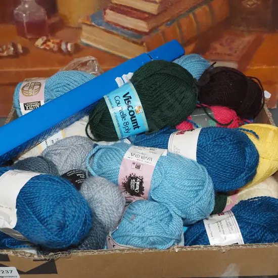 box of knitting yarns and needles
