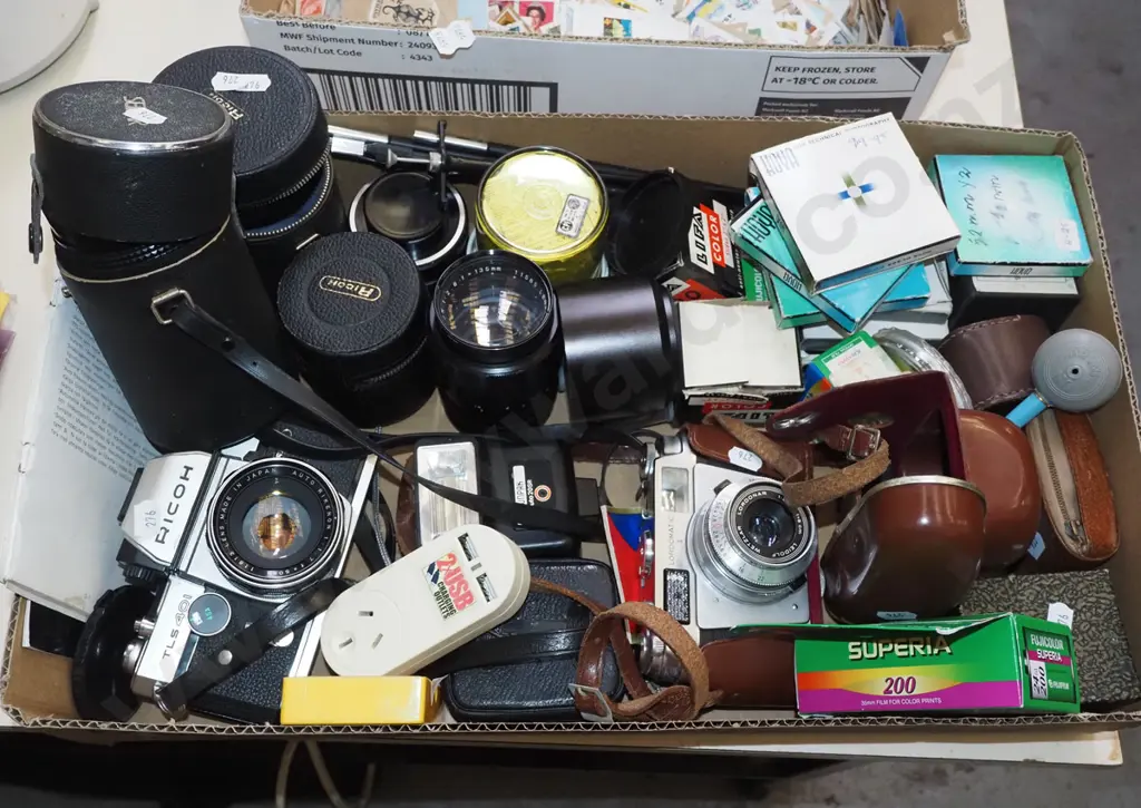 box of photographic accessories; cameras, films, lenses etc Image 1++