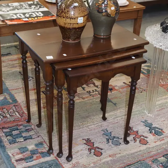 nest of mahogany tables