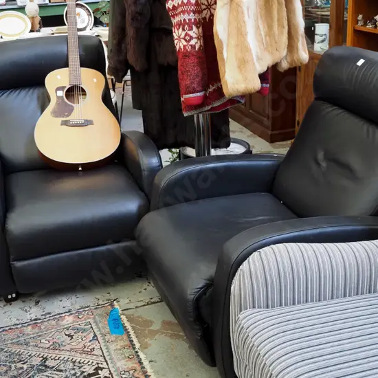 pair of Kovacs black leather reclining armchairs